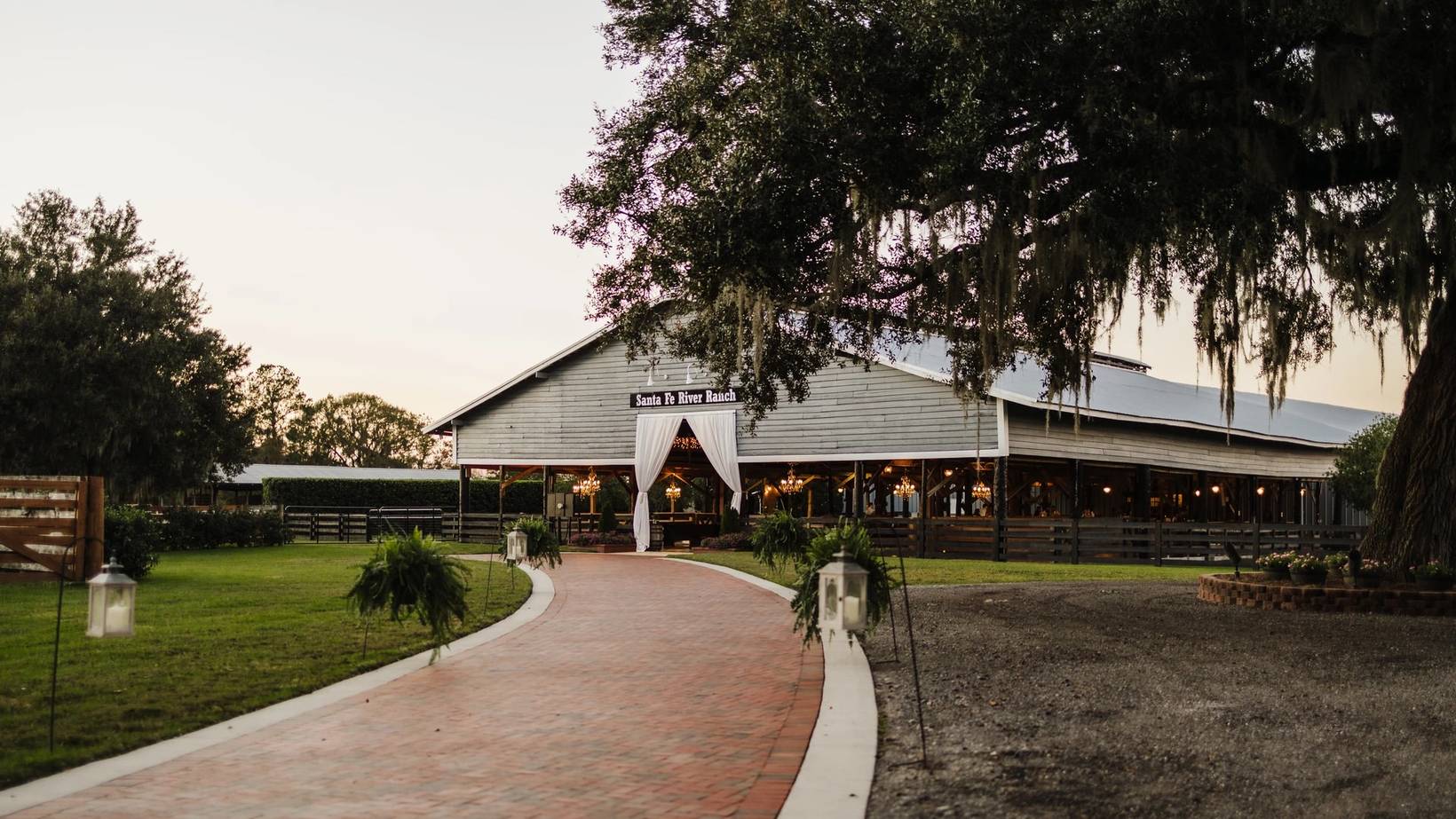 The pavilion at Santa Fe River Ranch at dusk, lit under live oaks hung with Spanish moss